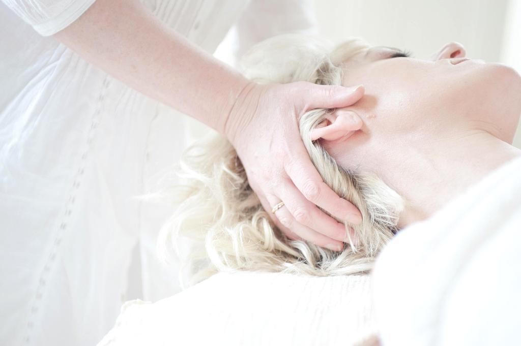 Aesthetician performing a laser treatment in a modern clinic room